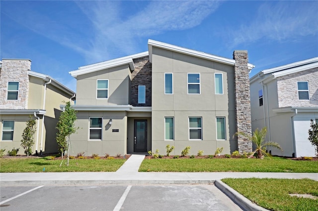 2857 Bookmark Dr, Kissimmee, FL 34746 - view of front of house featuring uncovered parking, stucco siding, and a front yard