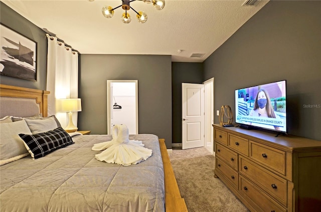 carpeted bedroom with an inviting chandelier