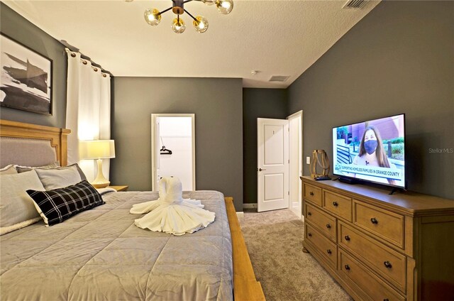 2857 Bookmark Dr, Kissimmee, FL 34746 - bedroom featuring visible vents, baseboards, a notable chandelier, a textured ceiling, and light colored carpet