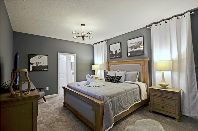 bedroom featuring a notable chandelier, carpet, and a textured ceiling