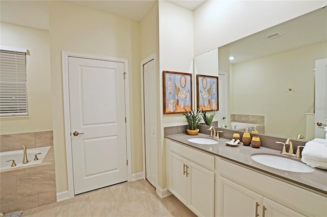 bathroom featuring tile patterned flooring, dual bowl vanity, and a relaxing tiled tub