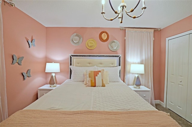 bedroom with an inviting chandelier, carpet, and a closet