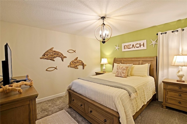 bedroom with a notable chandelier, carpet floors, and a textured ceiling