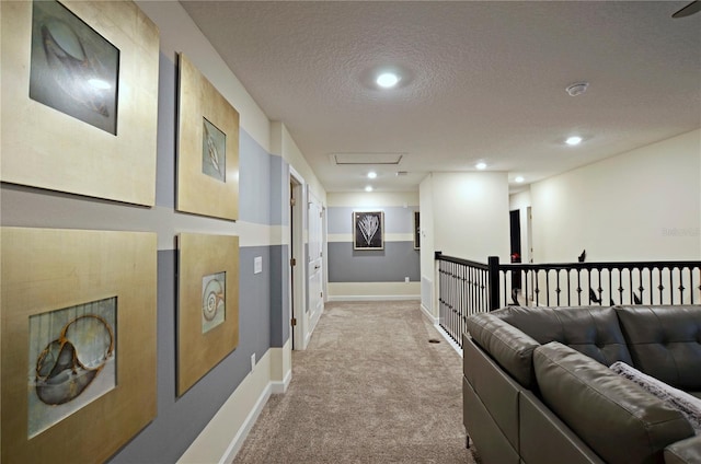 interior space with a textured ceiling and light colored carpet