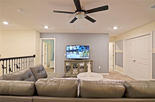 carpeted living room with ceiling fan