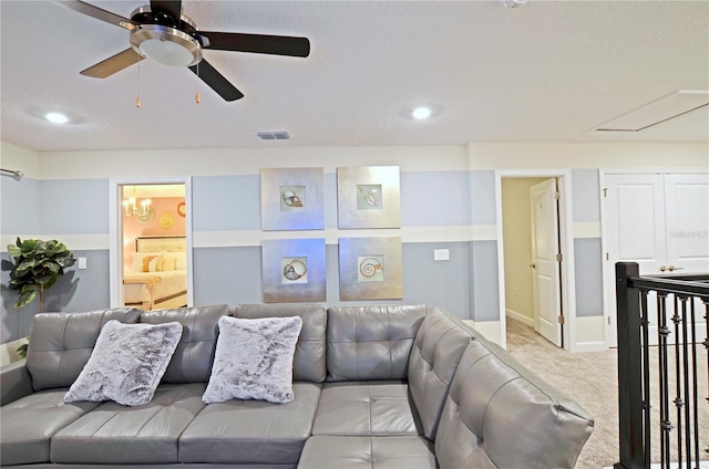 2857 Bookmark Dr, Kissimmee, FL 34746 - living room featuring a ceiling fan, visible vents, light carpet, attic access, and baseboards