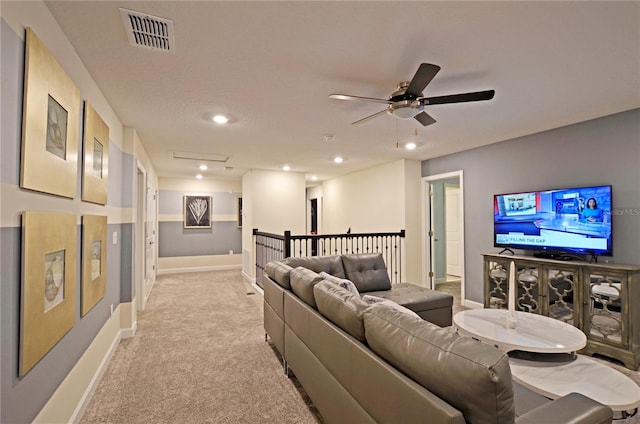 living room featuring light carpet and ceiling fan