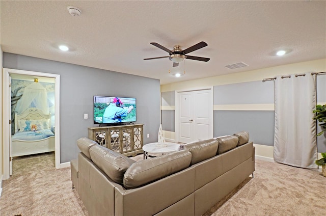 living room with light carpet, a textured ceiling, and ceiling fan