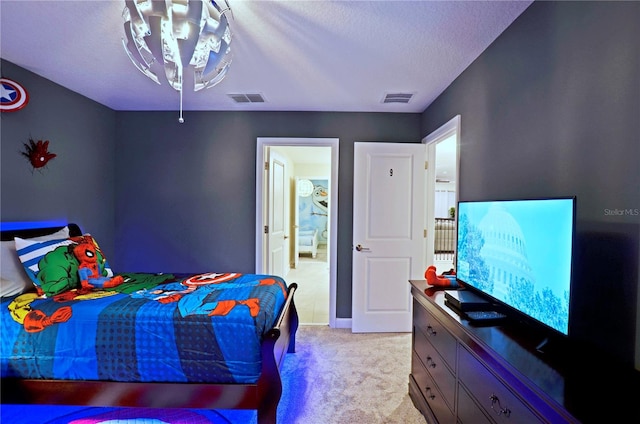 carpeted bedroom featuring an inviting chandelier and a textured ceiling