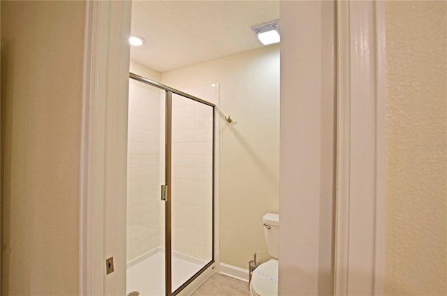 2857 Bookmark Dr, Kissimmee, FL 34746 - bathroom featuring a shower stall, tile patterned floors, visible vents, and toilet