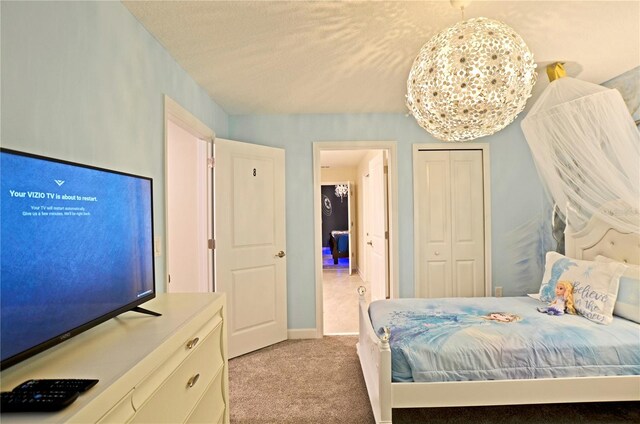 2857 Bookmark Dr, Kissimmee, FL 34746 - bedroom featuring a closet, baseboards, and light carpet