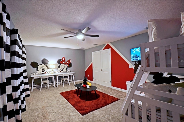 carpeted bedroom with a textured ceiling and ceiling fan