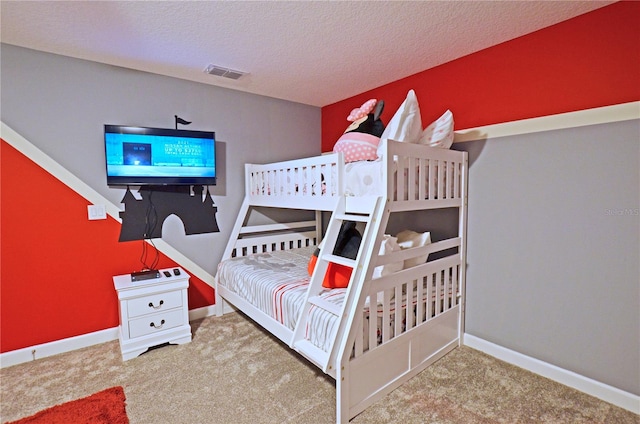 carpeted bedroom with a textured ceiling