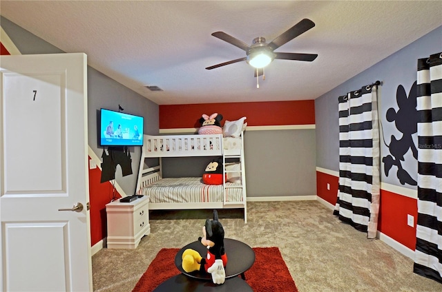 carpeted bedroom with a textured ceiling and ceiling fan