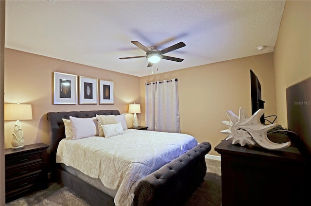 bedroom featuring a textured ceiling, carpet, and ceiling fan