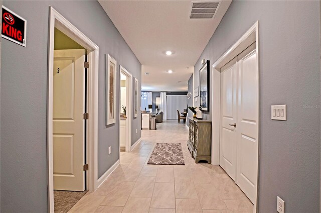 2857 Bookmark Dr, Kissimmee, FL 34746 - hallway with visible vents, baseboards, and light tile patterned floors