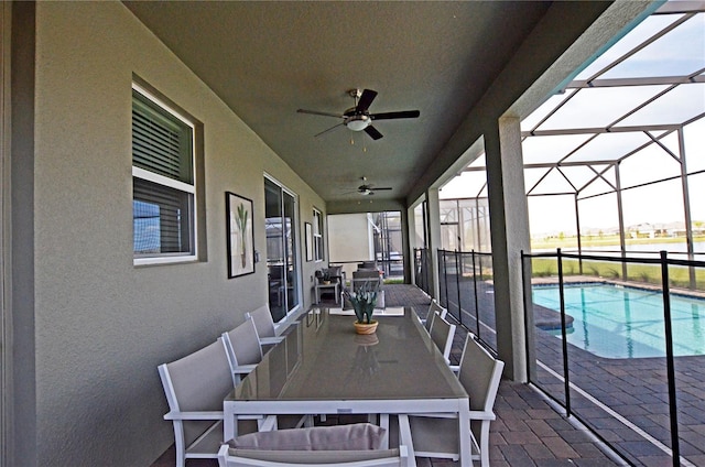 exterior space with glass enclosure and ceiling fan