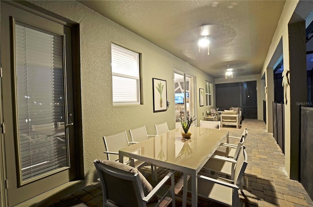 2857 Bookmark Dr, Kissimmee, FL 34746 - dining room with a textured wall, brick floor, and a textured ceiling