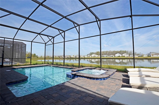 2857 Bookmark Dr, Kissimmee, FL 34746 - view of swimming pool featuring a patio, a pool with connected hot tub, a water view, and glass enclosure
