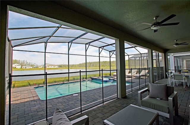 view of pool featuring a water view, a patio, ceiling fan, and a lanai