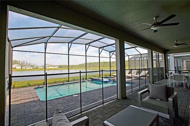 2857 Bookmark Dr, Kissimmee, FL 34746 - view of pool featuring a patio area, a water view, a pool with connected hot tub, a ceiling fan, and a lanai