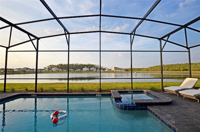 view of swimming pool with an in ground hot tub, a lanai, a water view, and a patio area