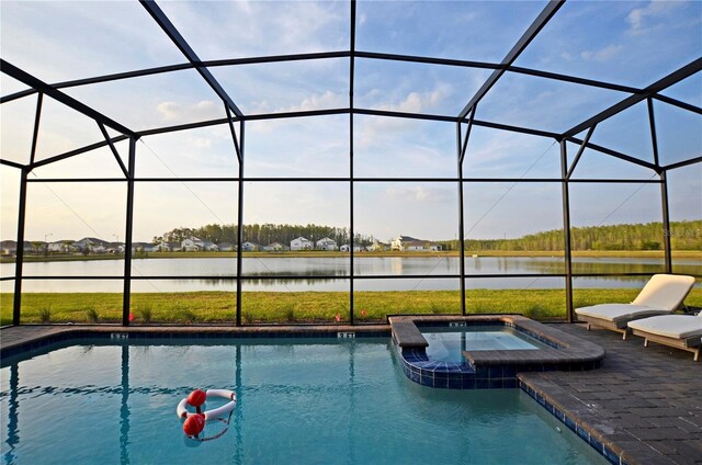 2857 Bookmark Dr, Kissimmee, FL 34746 - view of swimming pool featuring a pool with connected hot tub, a water view, and glass enclosure