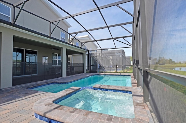 view of swimming pool featuring an in ground hot tub, a lanai, a patio, and ceiling fan