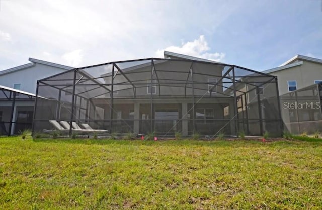 2857 Bookmark Dr, Kissimmee, FL 34746 - rear view of house featuring a yard, stucco siding, and a lanai