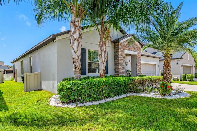 view of front of property featuring a garage and a front lawn