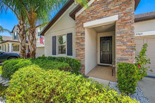 doorway to property with a garage