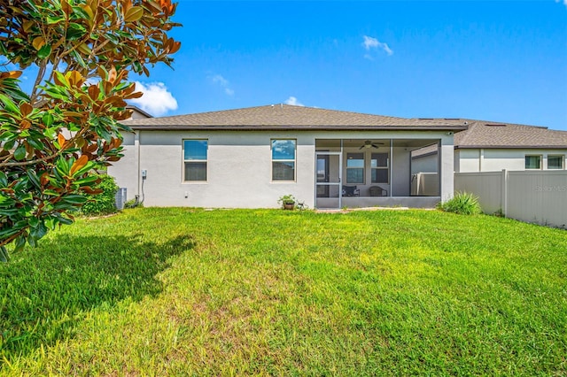 rear view of property featuring central AC, a yard, and ceiling fan