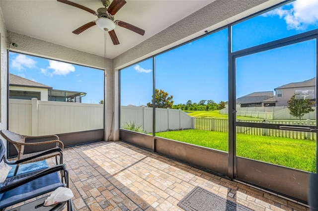 sunroom featuring ceiling fan