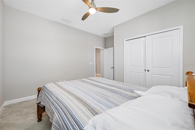 bedroom featuring a closet, light tile patterned floors, and ceiling fan