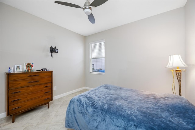 tiled bedroom featuring ceiling fan