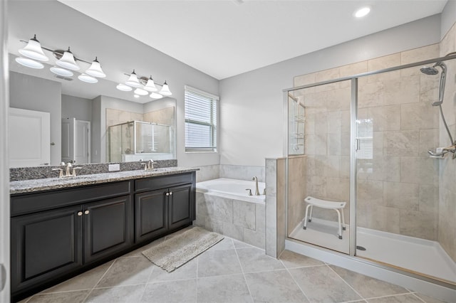 bathroom featuring dual vanity, tile patterned floors, and separate shower and tub