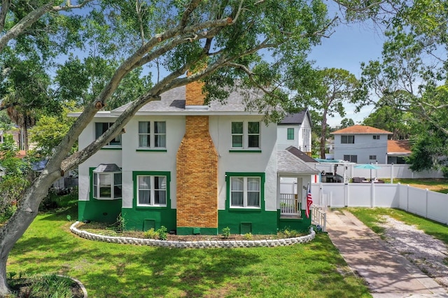 back of property featuring a lawn