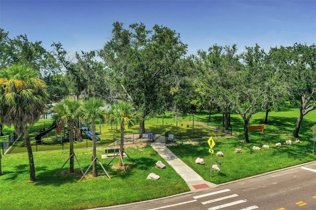 view of community featuring a playground and a yard