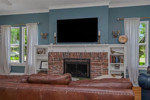 living room featuring a brick fireplace, crown molding, and hardwood / wood-style floors