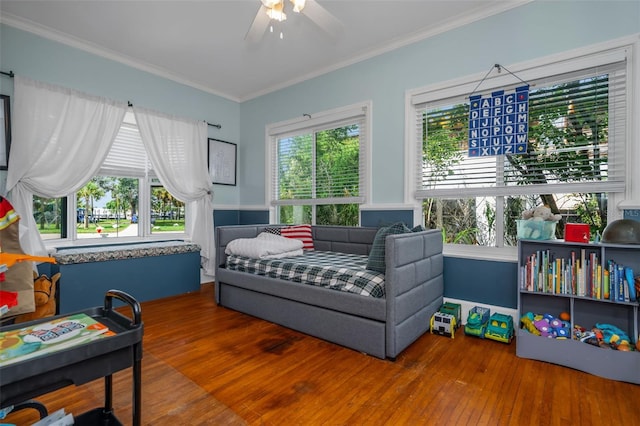 bedroom with ceiling fan, ornamental molding, and hardwood / wood-style flooring