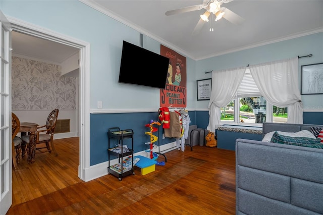 living room with ceiling fan, crown molding, and hardwood / wood-style flooring