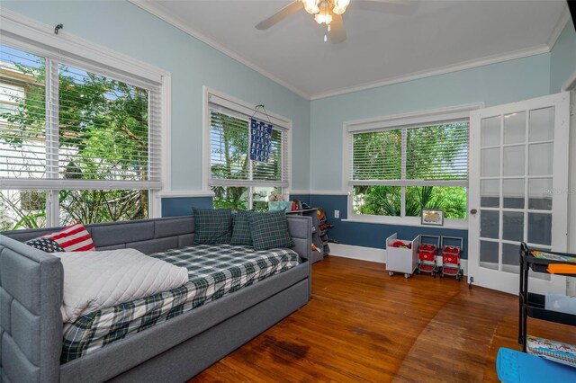 living room with ceiling fan, plenty of natural light, and crown molding