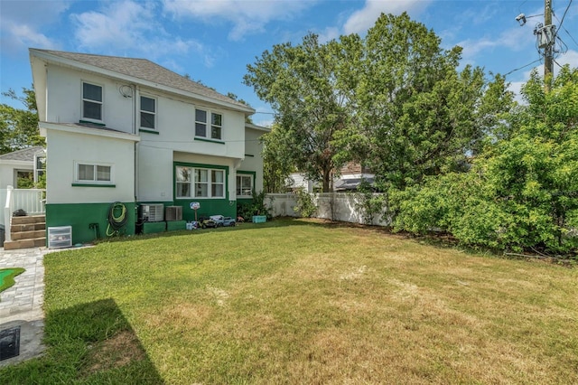 rear view of house featuring a yard