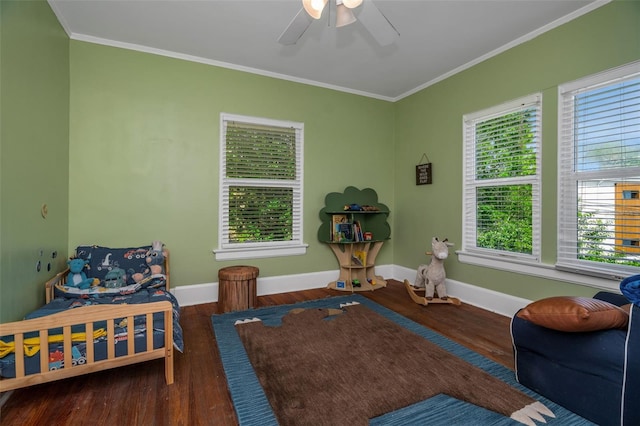 bedroom with ceiling fan, crown molding, and hardwood / wood-style flooring