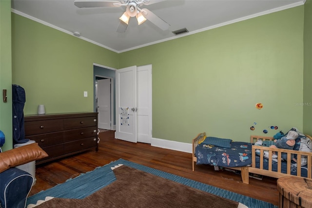 bedroom featuring ceiling fan, dark hardwood / wood-style floors, and ornamental molding