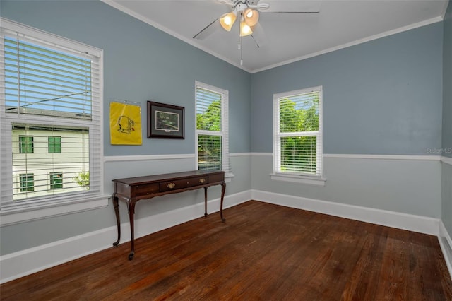 empty room featuring ceiling fan, dark hardwood / wood-style flooring, a wealth of natural light, and crown molding