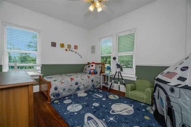 bedroom with dark wood-type flooring, ceiling fan, and crown molding