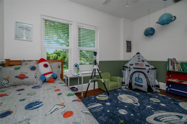 bedroom featuring ceiling fan, dark hardwood / wood-style flooring, and ornamental molding