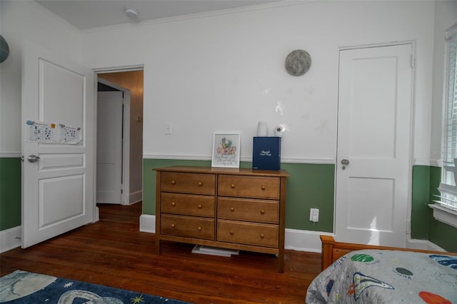 bedroom with dark hardwood / wood-style flooring and crown molding