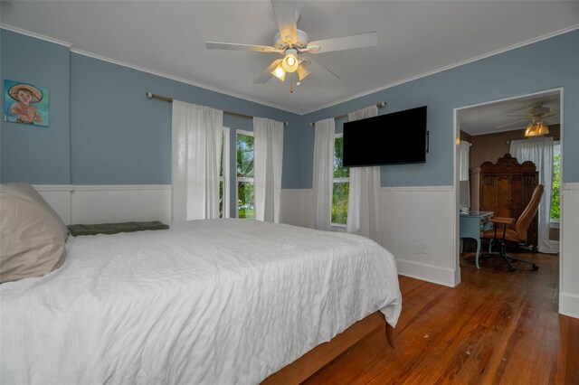 bedroom featuring ceiling fan, dark hardwood / wood-style flooring, and ornamental molding